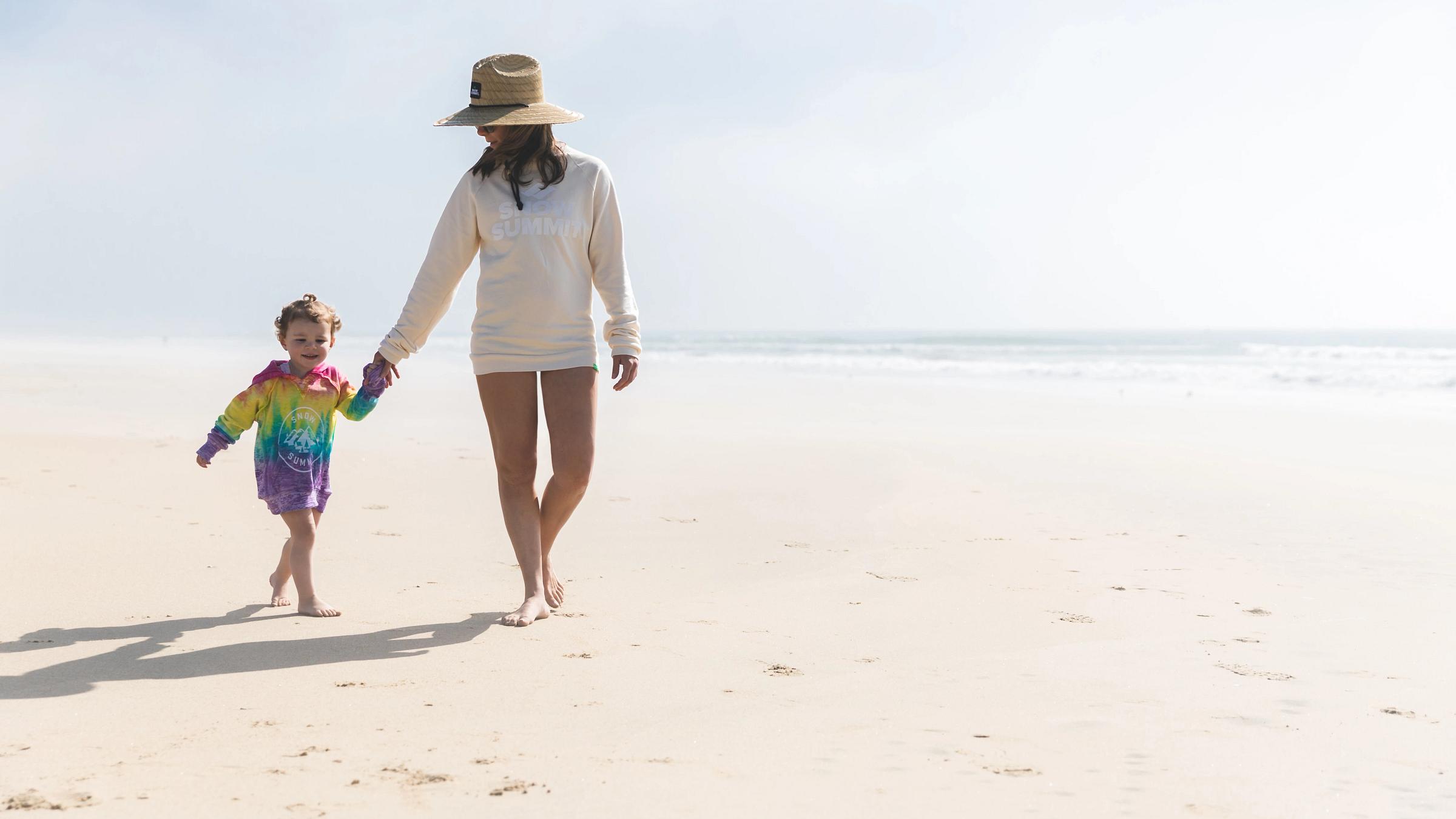 Mom and daughter on the beach in Snow Summit apparel