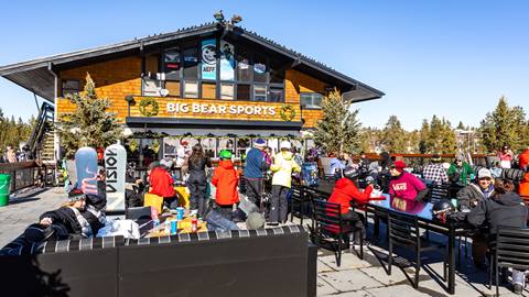 Big Bear Sports at Bear Mountain during the winter time with guests in snow clothes enjoying the sundeck