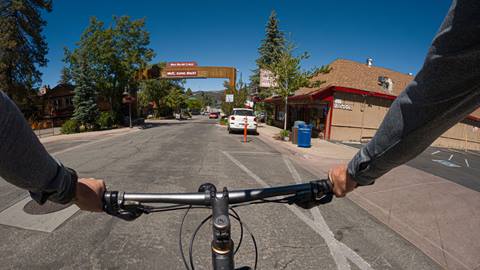 Chest view of adult riding bike in The Village at Big Bear Lake, CA