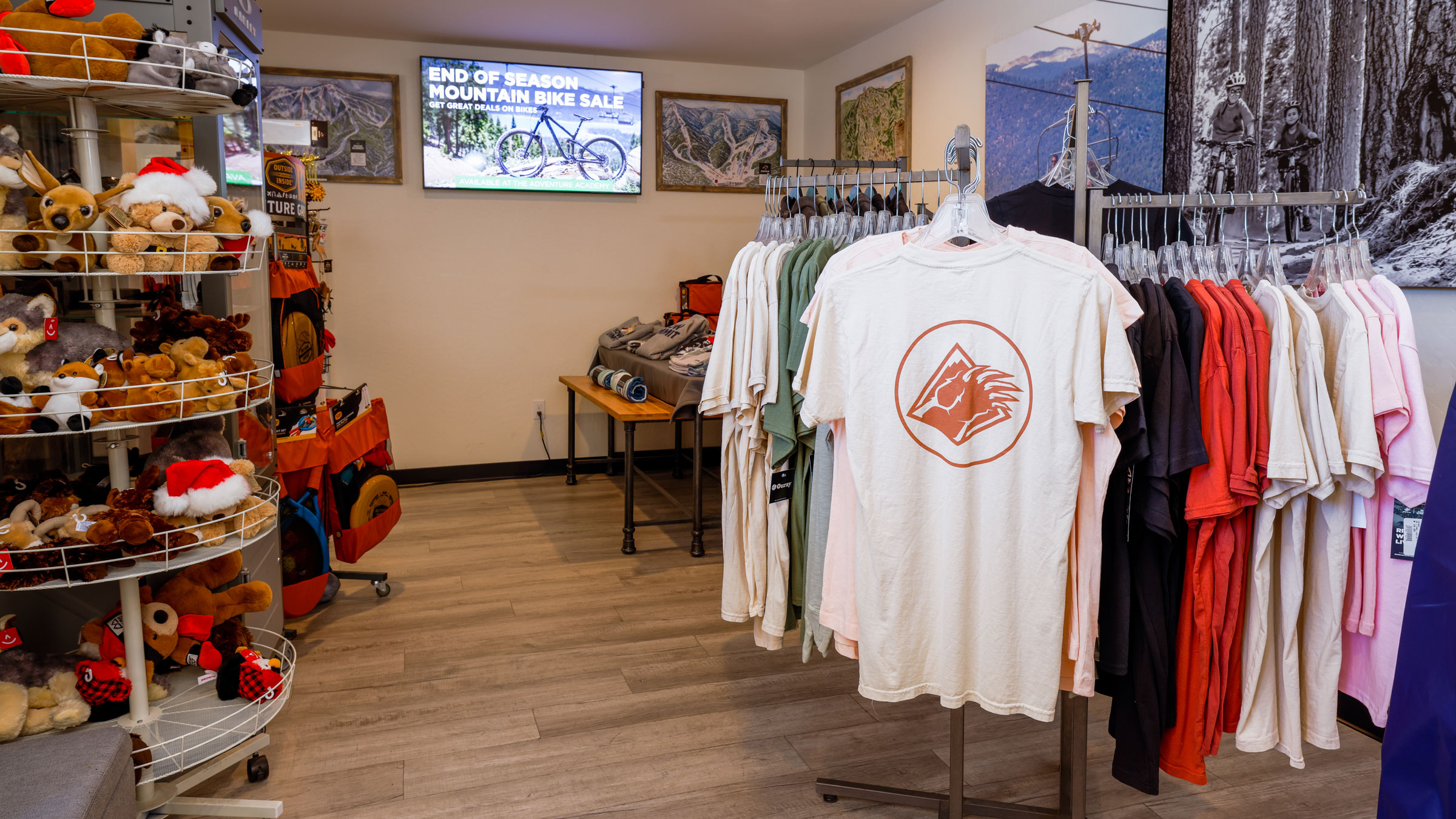 Plush toy animals and Big Bear Mountain Resort, Bear Mountain, and Snow Summit clothing displayed at BBMR Visitors Center Station.