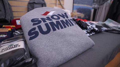 Snow Summit red white and blue logo sweatshirt with socks and varying products on retail display table.