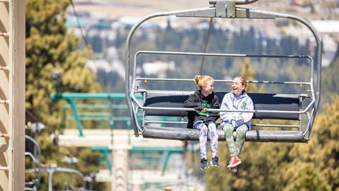 two lift ticket holders riding the scenic sky chair