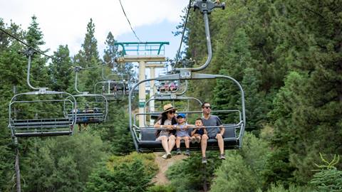two adults and two children lift ticket holders riding the scenic sky chair
