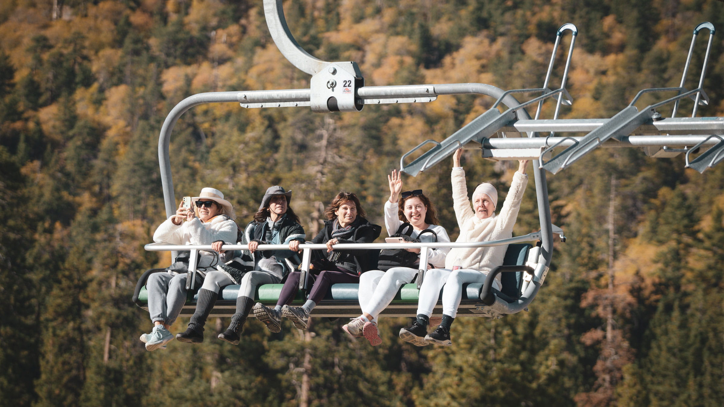 Four friends riding the Scenic Sky Chair in the summertime at Snow Valley