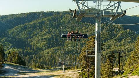 A family of four riding the Scenic Sky Chair at Snow Valley