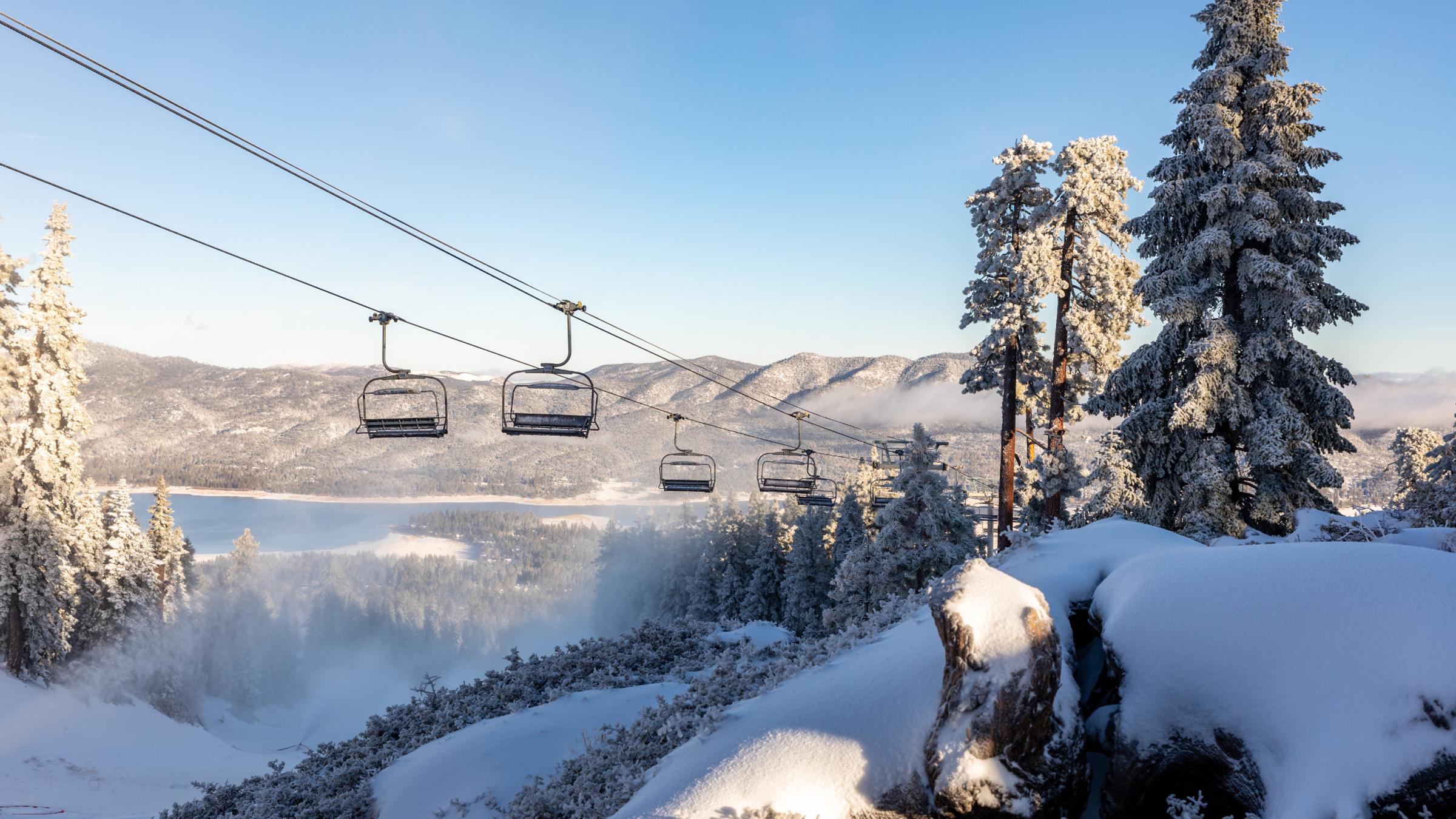 Charlifts with a snowy lake in the background.