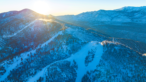 Snowy shot of Bear Mountain during sunrise
