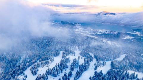 Drone arial image during morning overlooking the lake and ski resort