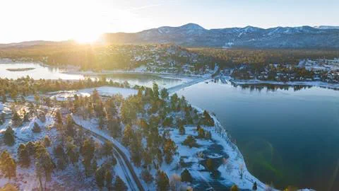 Drone image of Big Bear Lake at sunrise with snow on the ground