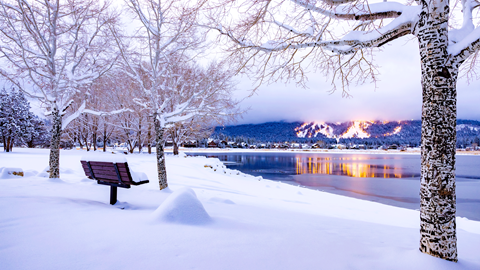 snowy winter day view from across the lake, looking at snow summit's lite up slopes
