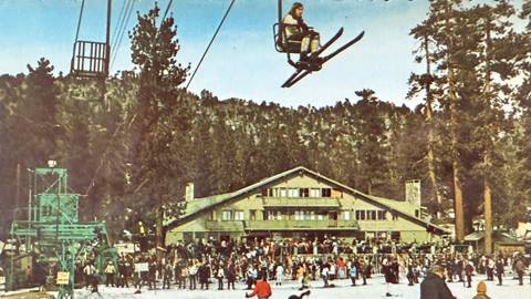 Colored picture of the base area and lodge of Snow Valley during winter, with an abundance of skiers and alpine enthusiasts enjoying the snow.