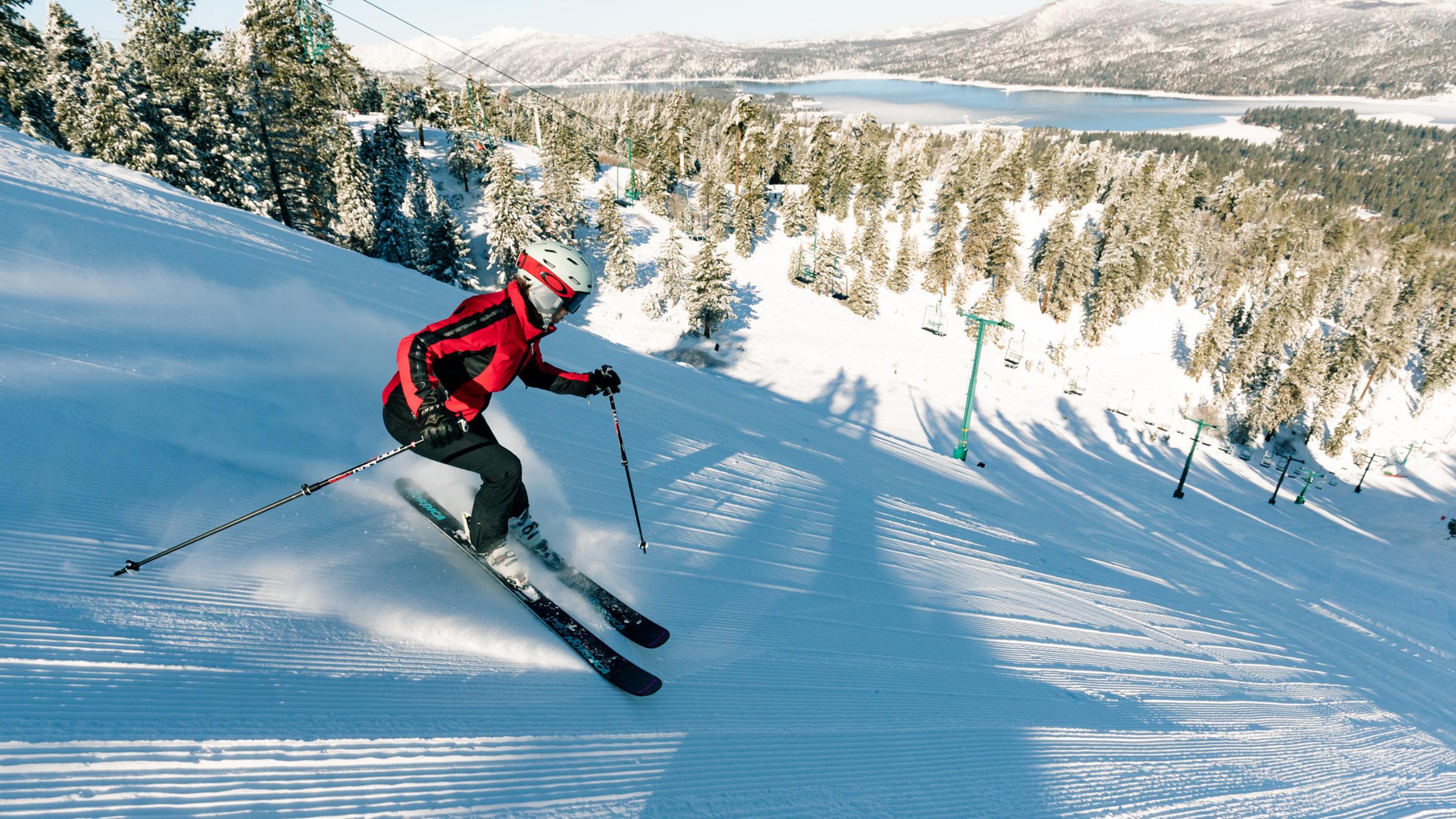 Woman skiing with lake scenic background