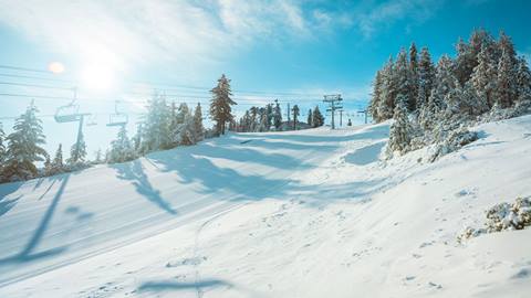 Bluebird day at Snow Valley with a groomed run in the background