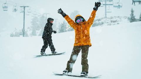 Two snowboarders on the slopes at Snow Valley on a snow day