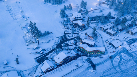 An arial drone image of the base area and parking lot, covered in snow, at Snow Summit.