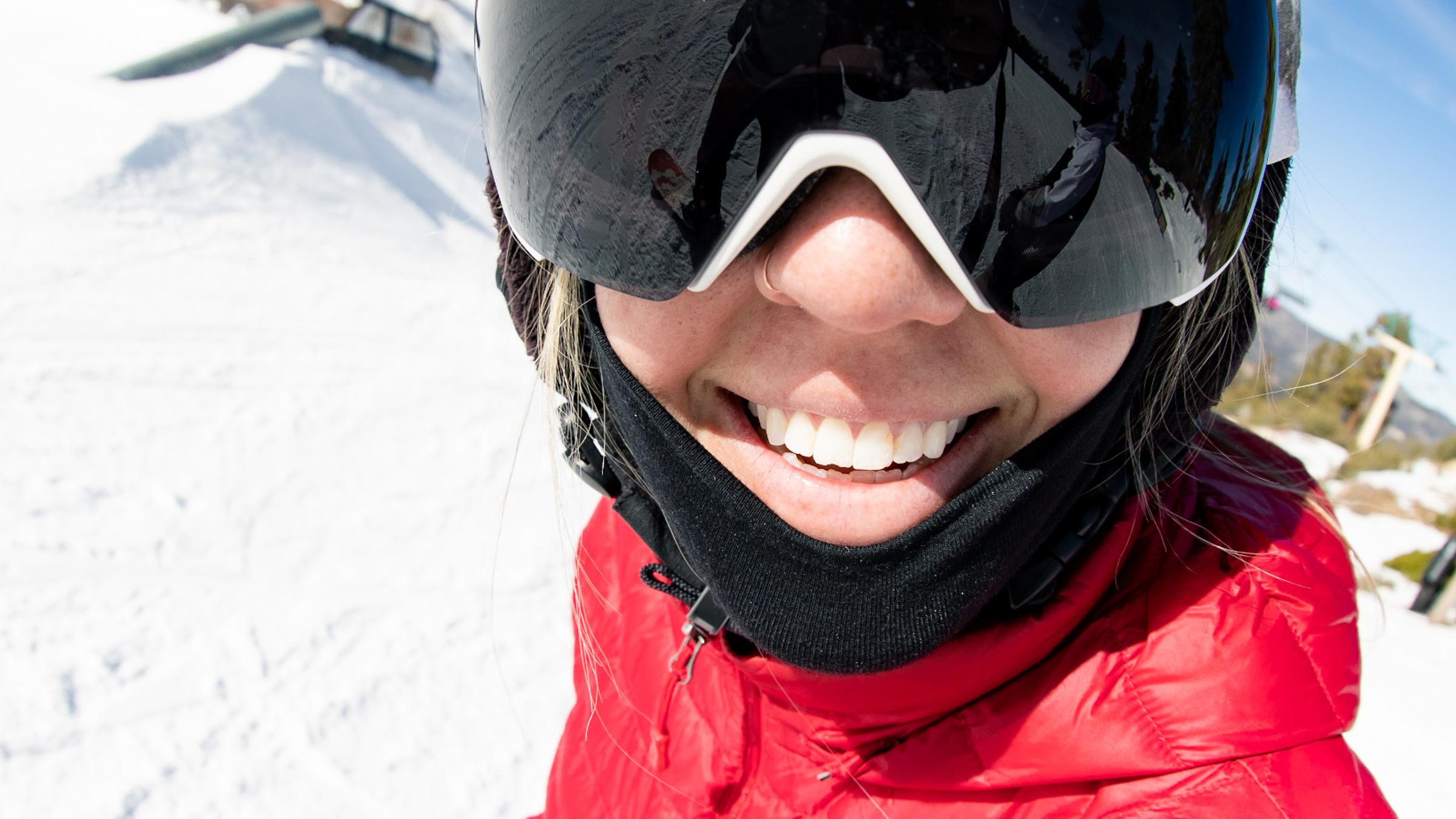 female wearing goggles smiling at camera