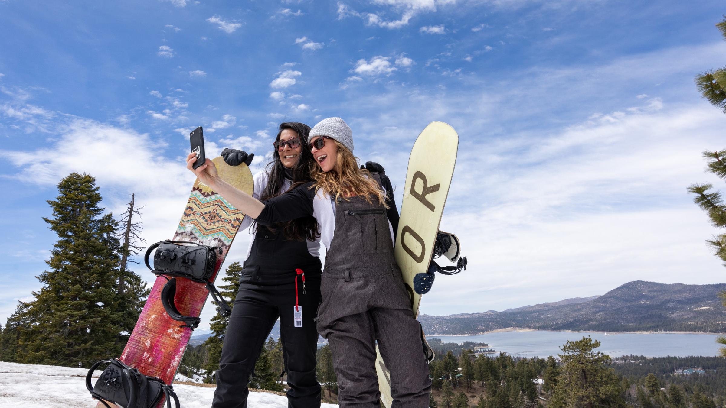 Two snowboarder girls taking a selfie