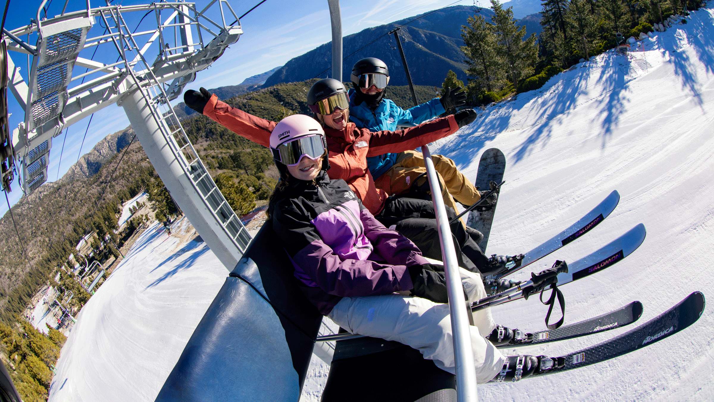 group of ski and snowboarding friends on a chairlift