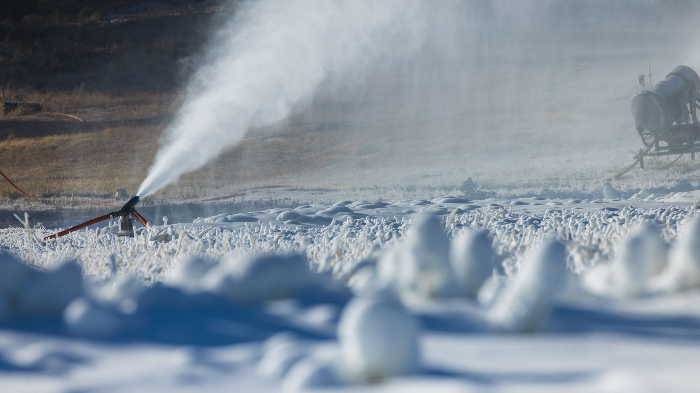 Snow gun blowing snow onto the ski hill.