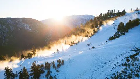 Morning sunrise drone shot of The Edge trail with snowmaking at Snow Valley
