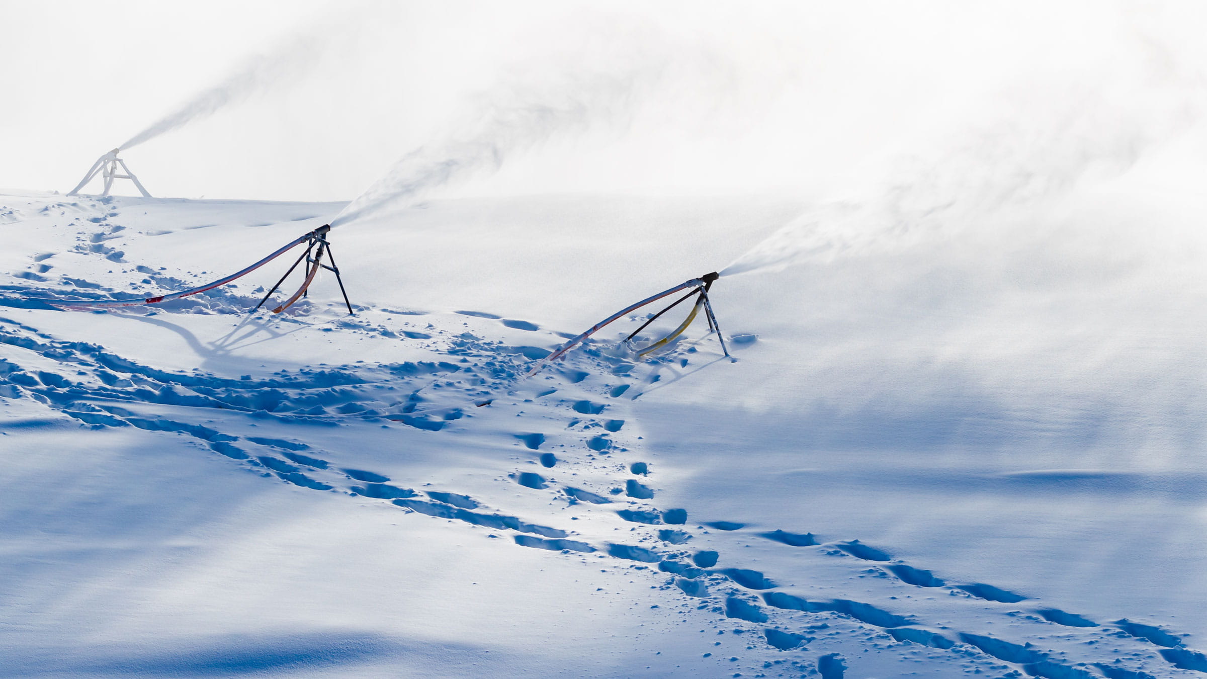 snow guns shooting out compressed water turning into snow