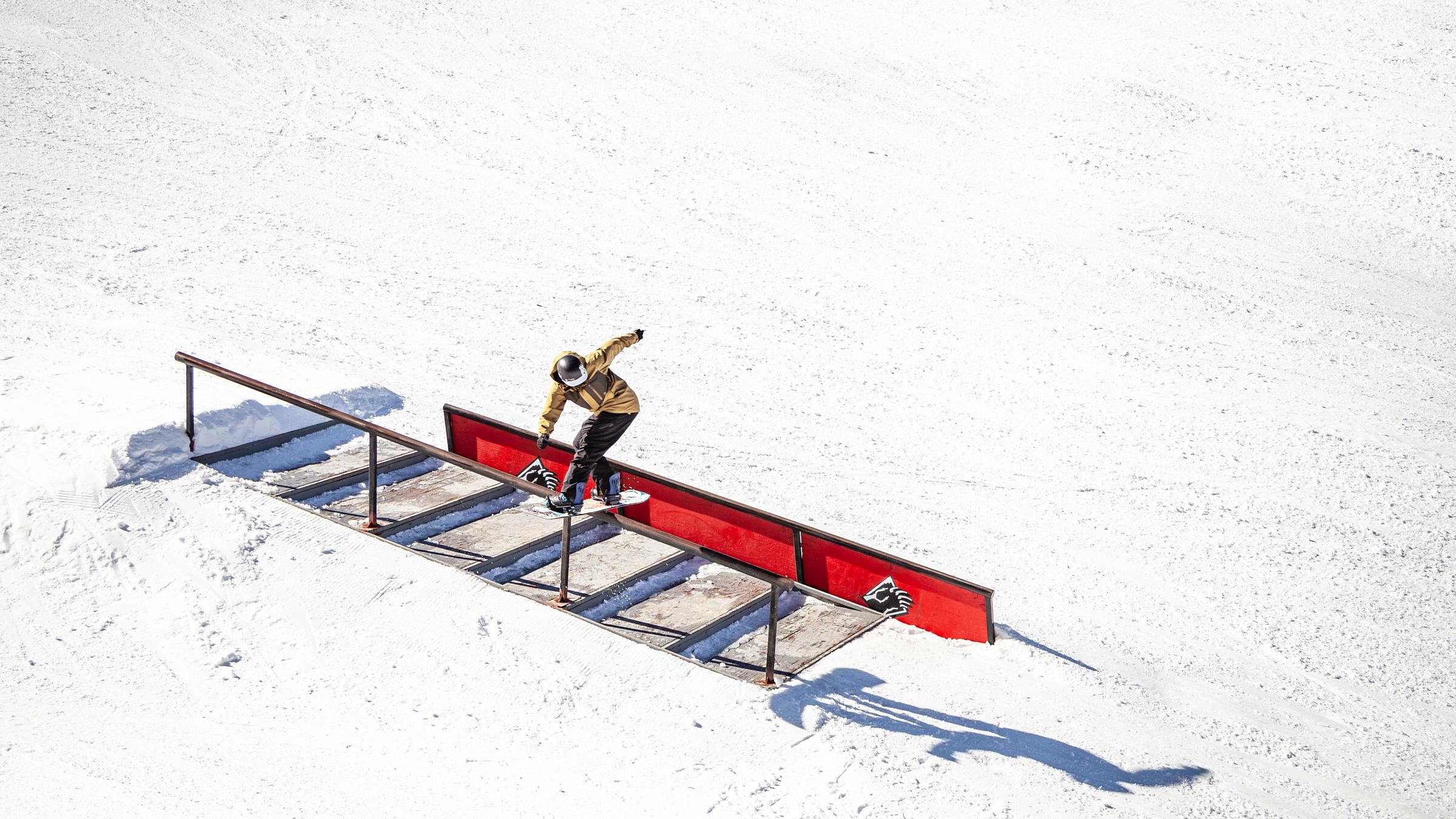 Snowboarder going down a rail