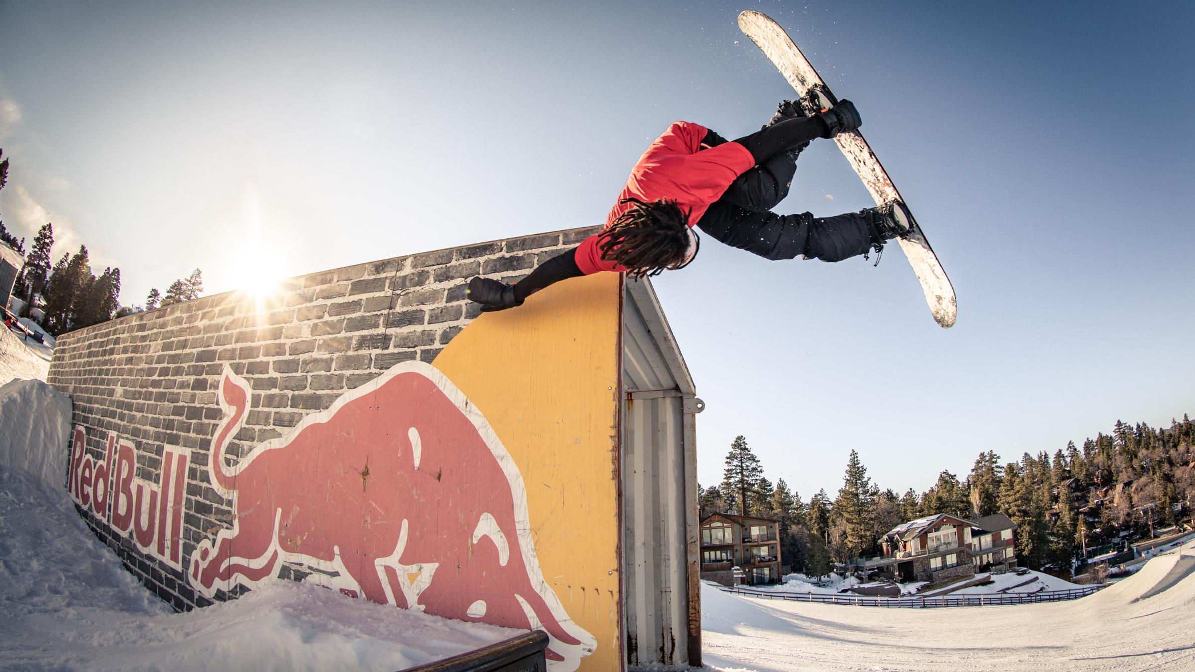 Snowboarder doing a trick on a container