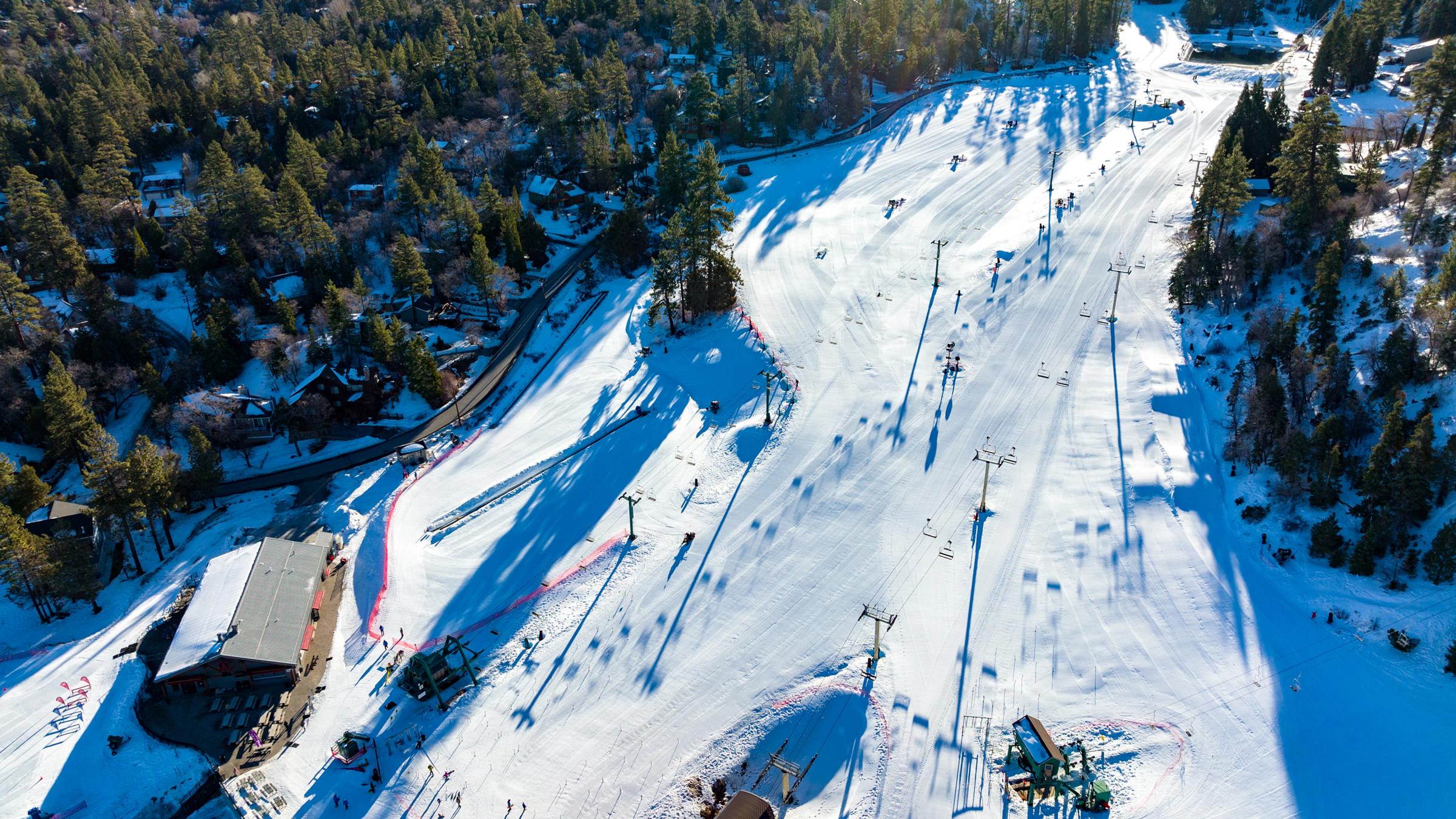 Drone view of a Big Bear Mountain Resort covered in snow.