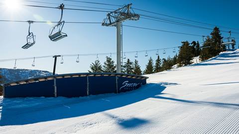 Black metal terrain park features in the snow at snow valley in the winter