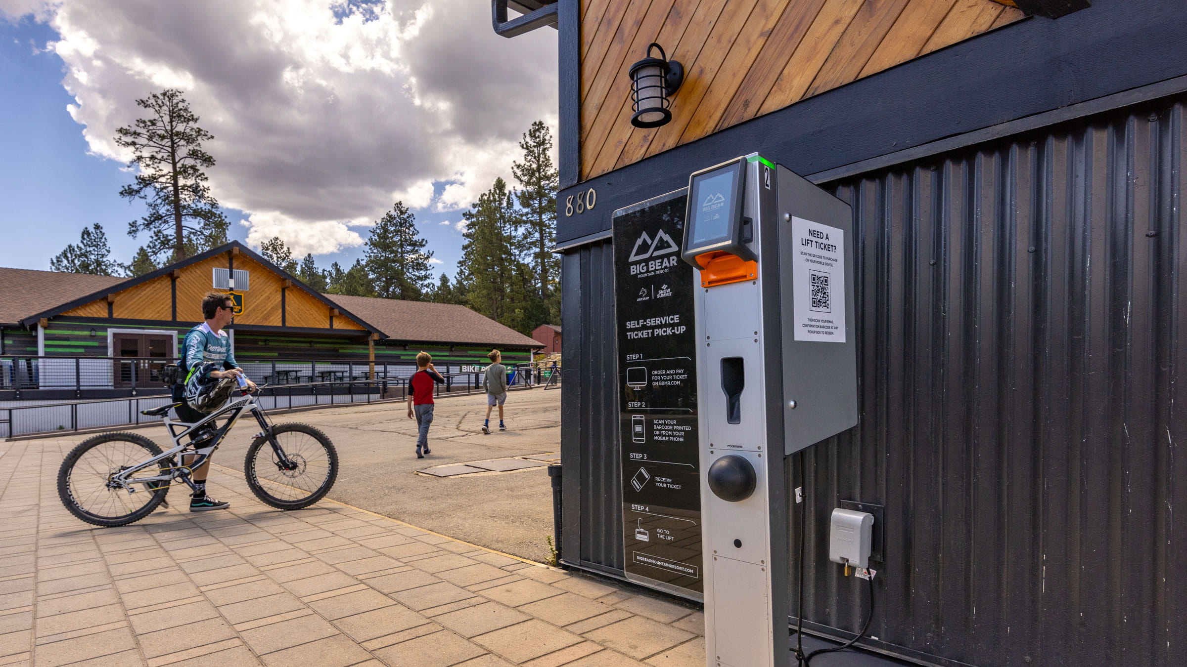 Pick up box with a mountain biker walking across the bricks behind it