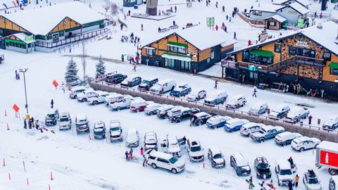 Drone shot of Snow Summit and parking lot with new snowfall