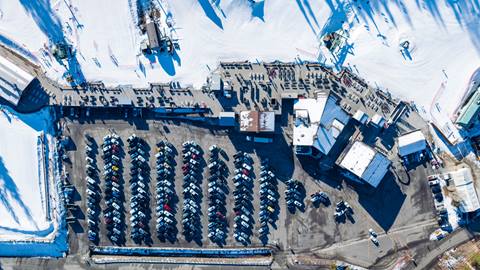 Drone photo of Bear Mountain Base Area including sun deck and parking lot.