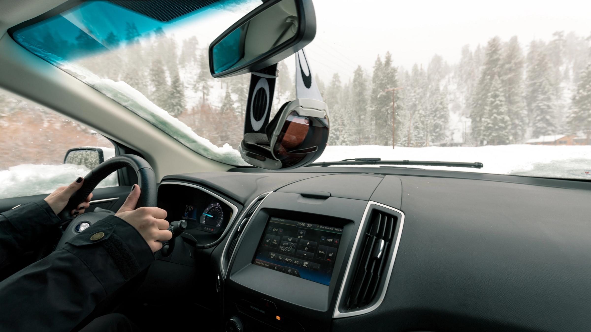 Female driving in the snow.