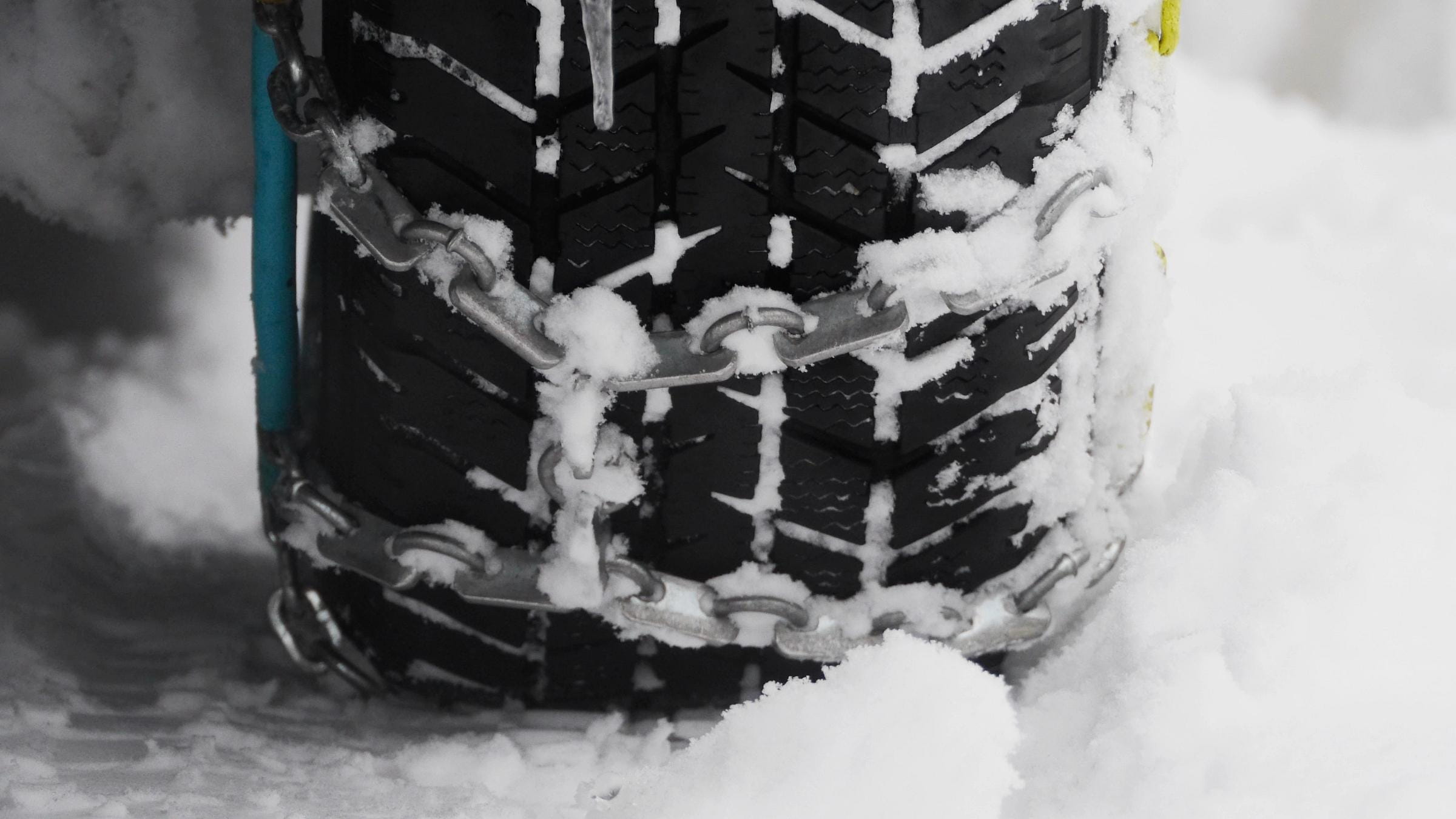 Snow chains outside at a wheel in winter