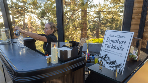 Bartender making a drink during cocktail hour in the forest