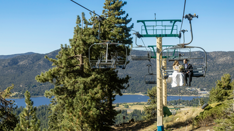 Bride and groom in the summer taking a scenic sky chair ride at snow summit