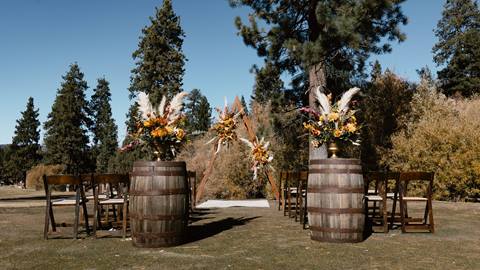 Outdoor wedding reception with barrels and fall decor outdoors in at the golf course