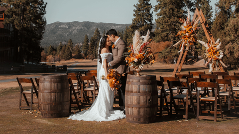 Married couple standing outdoors in the mountains for their reception