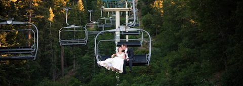 Married couple riding the chairlift in the summertime at snow summit
