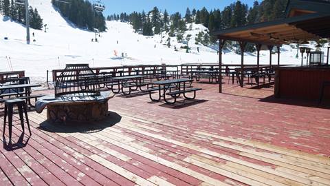 Deer Meadow Grill sundeck with snow on the slopes