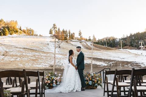 Bride and groom in front of Bear Mountain's ski slopes